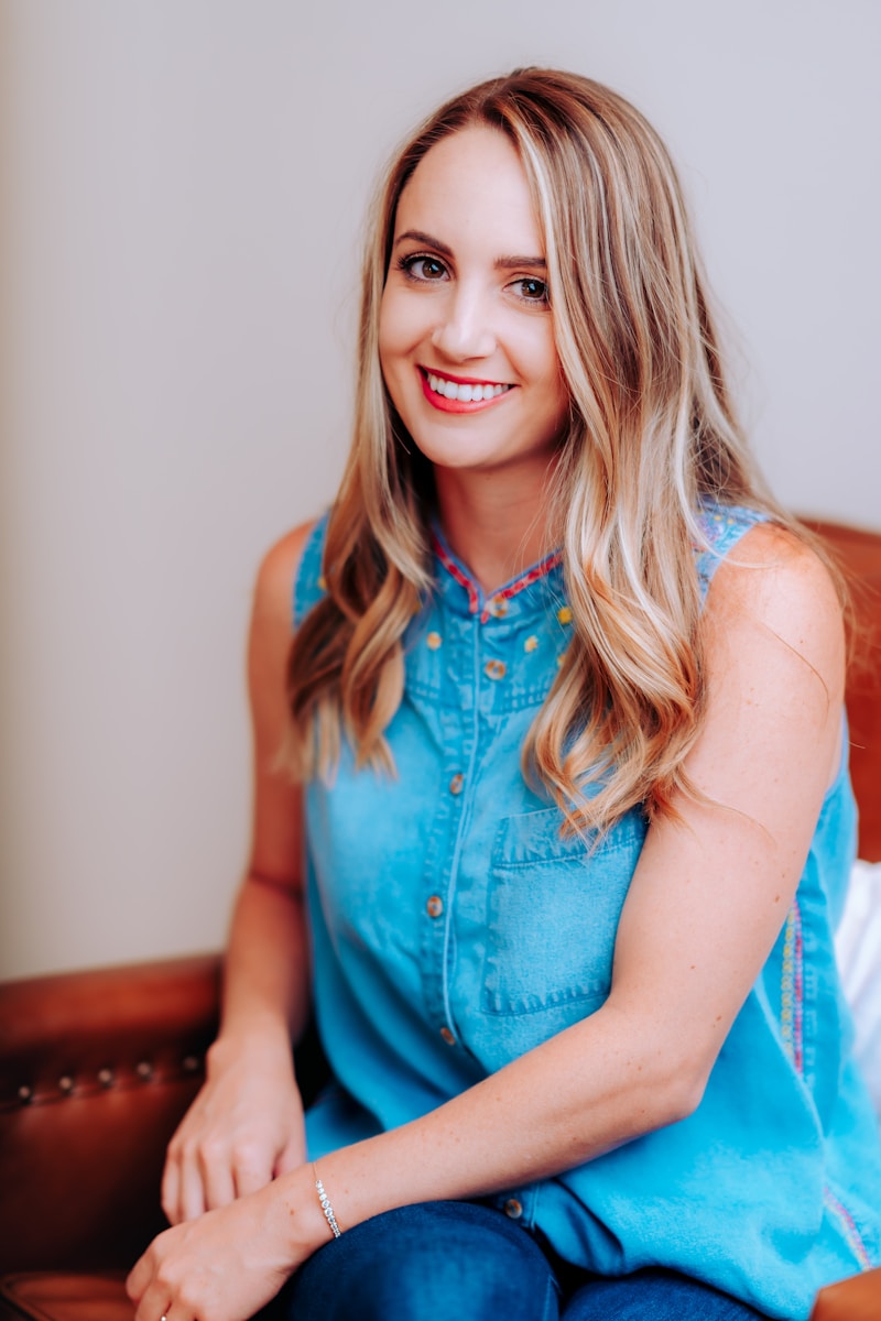 smiling girl in blue sleeveless dress